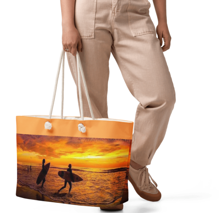 Traci Surfing at Sunset Weekender Tote Bag — Bold Golden Hour Beach Tote Bag Featuring Two Surfers Silhouetted Against a Dramatic Orange and Gold Sunset Sky for Women Who Live for the Ocean and the Last Light of Day
